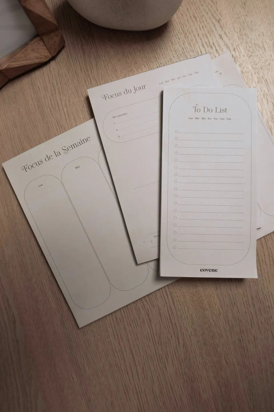 Three notebooks sitting on top of a wooden table